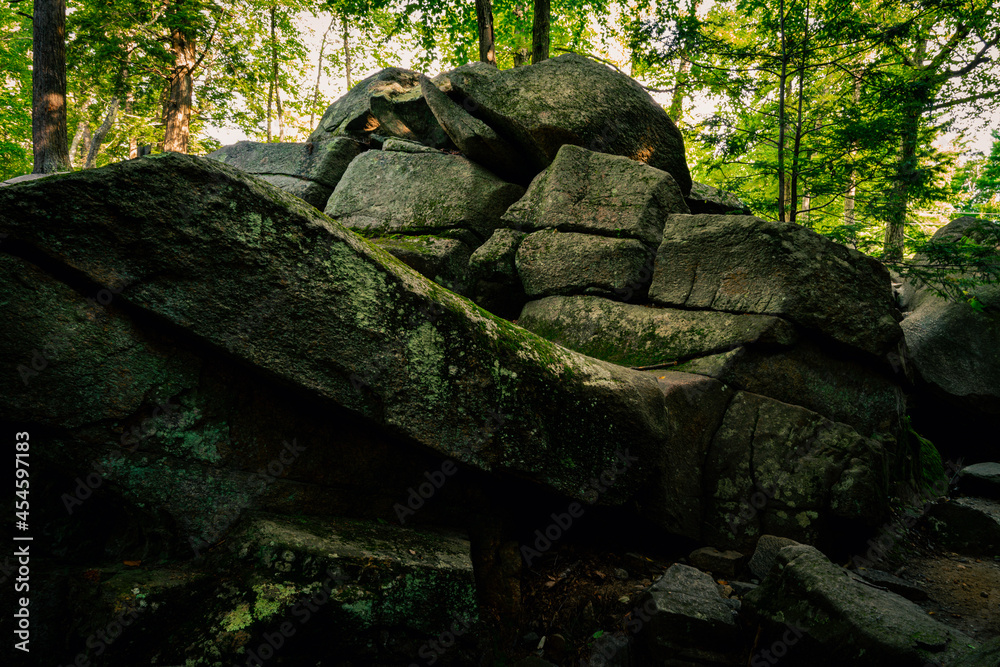 Fototapeta premium Majestic glacial stone hill at Purgatory Chasm Park in Massachusetts. Abstract geological shapes and patterns of curving flow and mystical power.
