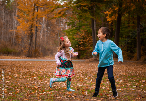 Girl chasing boy in fall