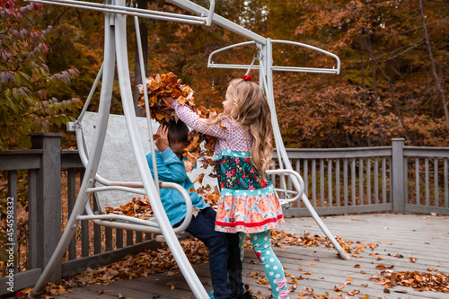 Girl dumps leaves on boy