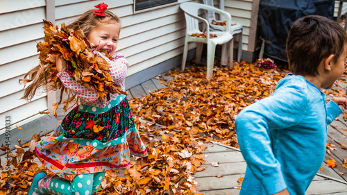 Girl throwing leaves at boy