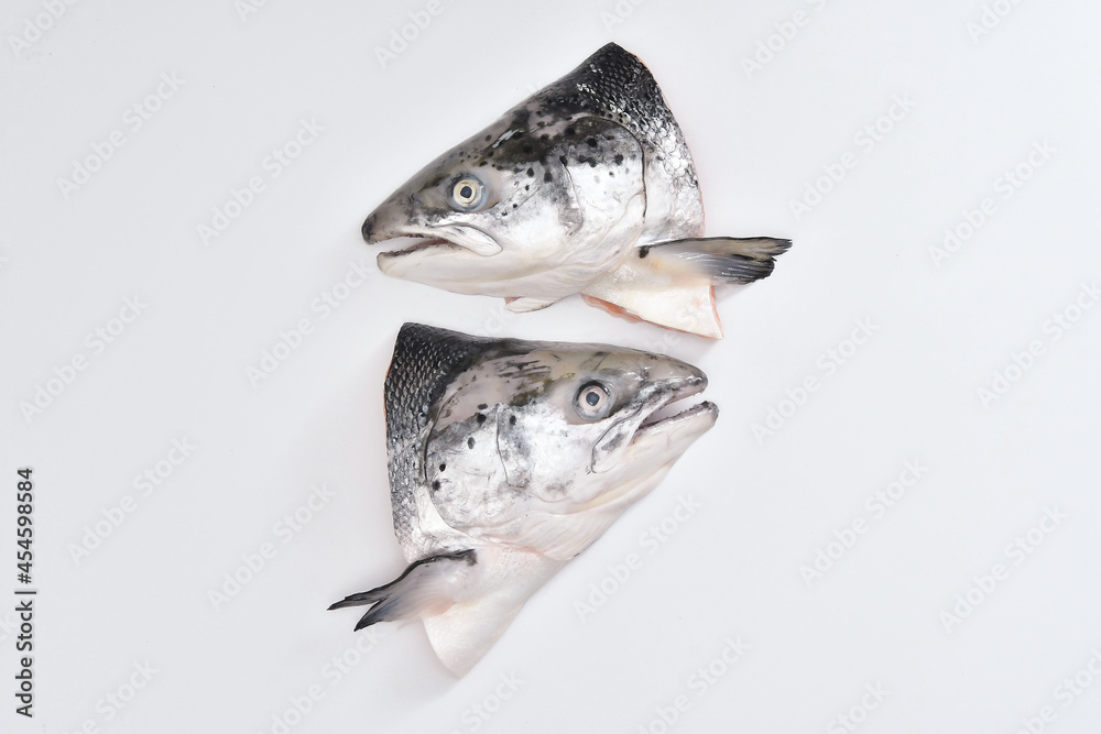 salmon head on a white background Fish heads are commonly used to make steamed soy sauce dishes to add value.