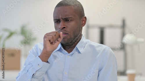 Portrait of Sick African Man Coughing in Office