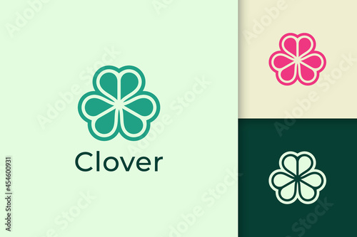 Clover leaf logo in abstract shape with green color represent lucky or herb