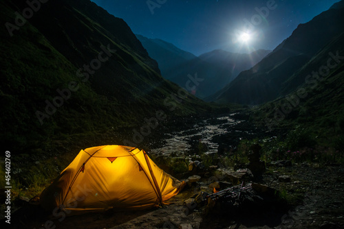 illuminated tent in the mountains at night