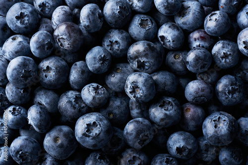Fresh juicy blueberries background. Flat lay top view copy space. Healthy berry, organic food, antioxidant, vitamin, blue food.
