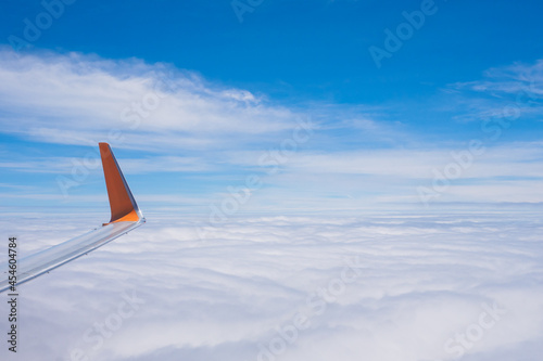 The wing tips of the airplane against the clear blue sky background while travelling in the summer.