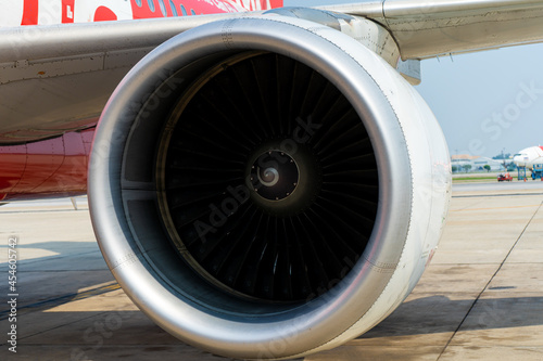 Close-up of a turbine engine of a passenger plane in an airport parking