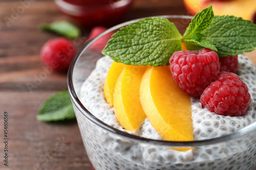 Delicious chia pudding with raspberries  peach and mint in glass  closeup