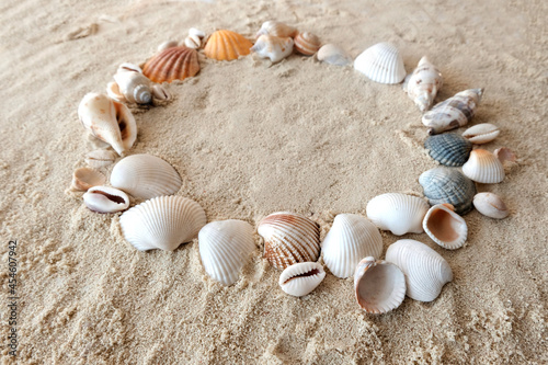 Sea stones and seashells on white sand at sunset. Copy space, Resumption of tourist trips, recovery from the crisis
