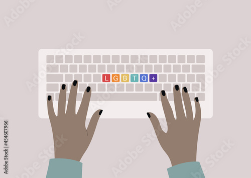Hands typing on a keyboard, top view, rainbow buttons with an LGBTQ+ sign, queer community support