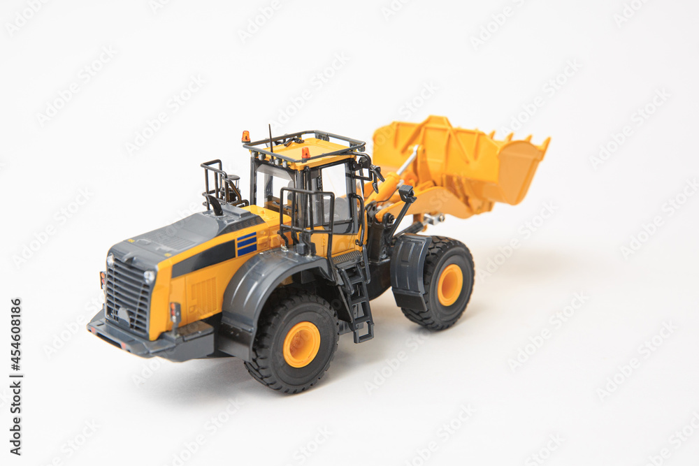 Highly detailed yellow single-bucket forklift, scale model of specialized equipment on white background, bulk loader. Highly detailed yellow single-bucket forklift, scale model of specialized equipment on white background, bulk loader.