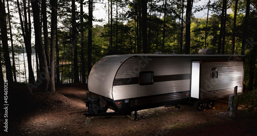 Lighted camping trailer late in the afternoon