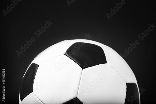 Leather football ball on black background, closeup