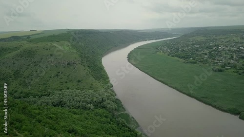 Flight over the river and small village in spring. Moldova republic of. Molovata village. River Dniester. photo