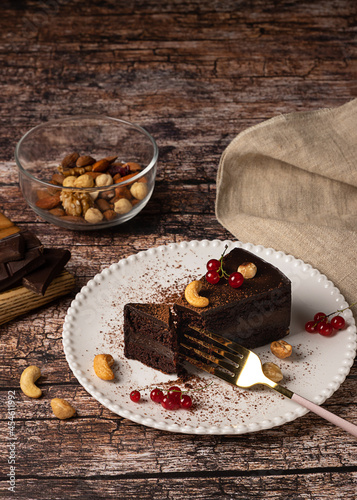 Raw vegan chocolate cake on dark vintage background