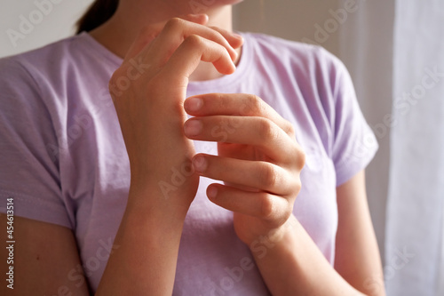 Teenage girl practicing EFT - emotional freedom technique - tapping on karate chop point photo