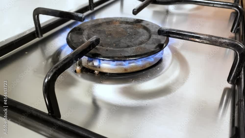 Glowing blue flame igniting in a domestic kitchen stove Glowing blue flame igniting in a domestic kitchen stove