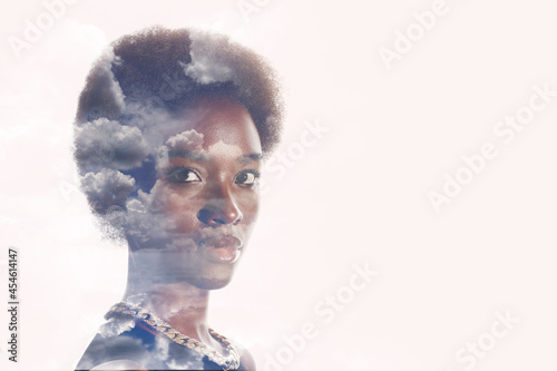 Multiple exposure image with clouds and sky inside african american woman portrait. Mental health and calm.