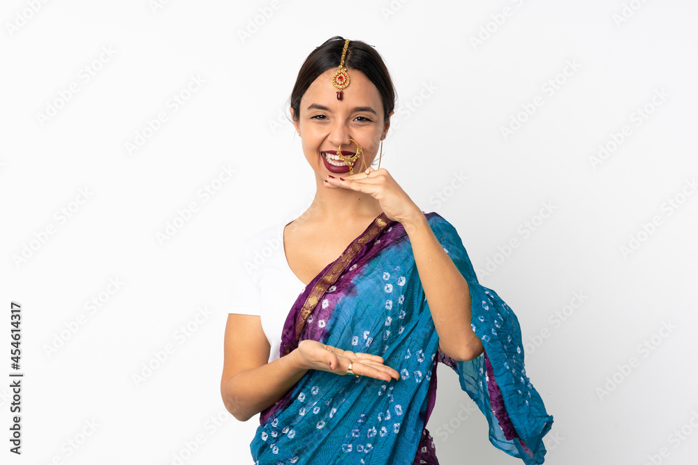 Young indian woman isolated on white background holding copyspace imaginary on the palm to insert an ad Young indian woman isolated on white background holding copyspace imaginary on the palm to insert an ad