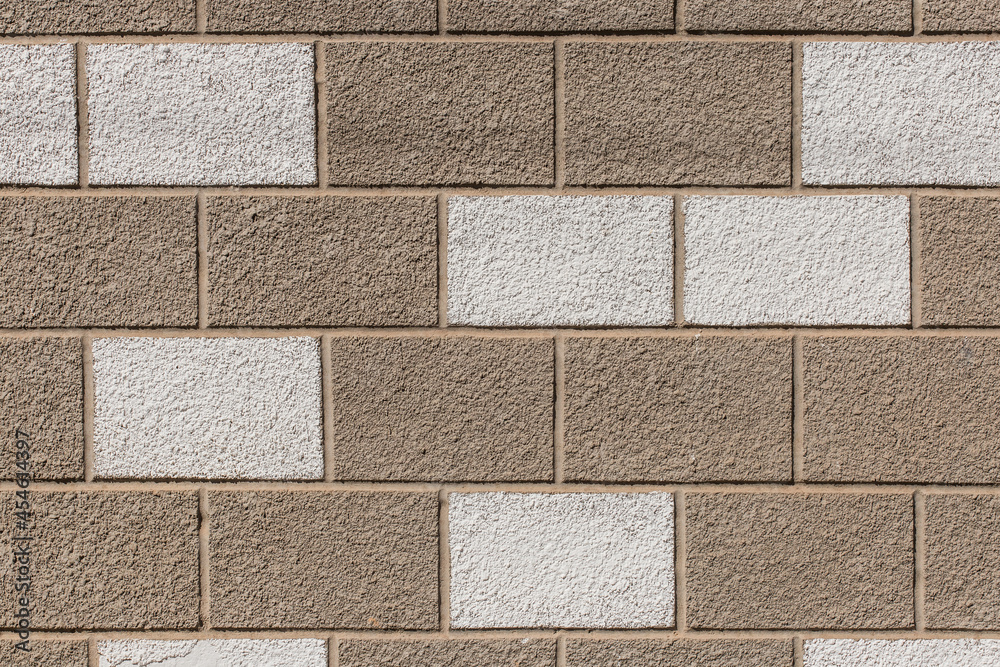 Fototapeta premium White and brown painted brick blocks pattern stone wall exterior city texture background