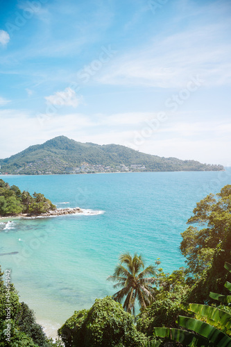 Beach with coconut trees and mountains.View of the coast of the island of island.