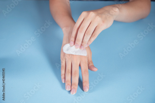 woman cleaning hands with a napkin
