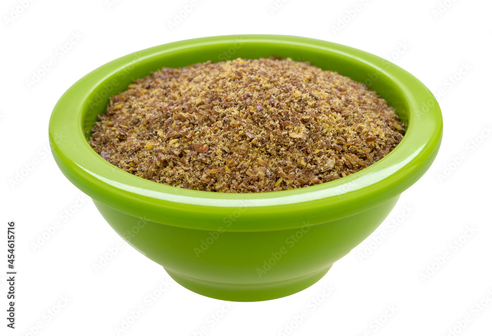 Freshly ground flaxseed meal in a green bowl side view. Freshly ground flaxseed meal in a green bowl side view.