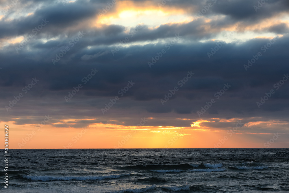 Picturesque view of beautiful sky with clouds over sea at sunset Picturesque view of beautiful sky with clouds over sea at sunset