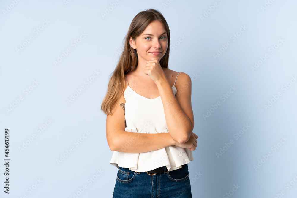 Young Lithuanian woman isolated on blue background thinking an idea while looking up Young Lithuanian woman isolated on blue background thinking an idea while looking up