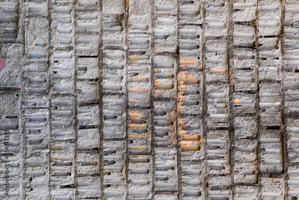The wall is made of large white old bricks from Soviet times.