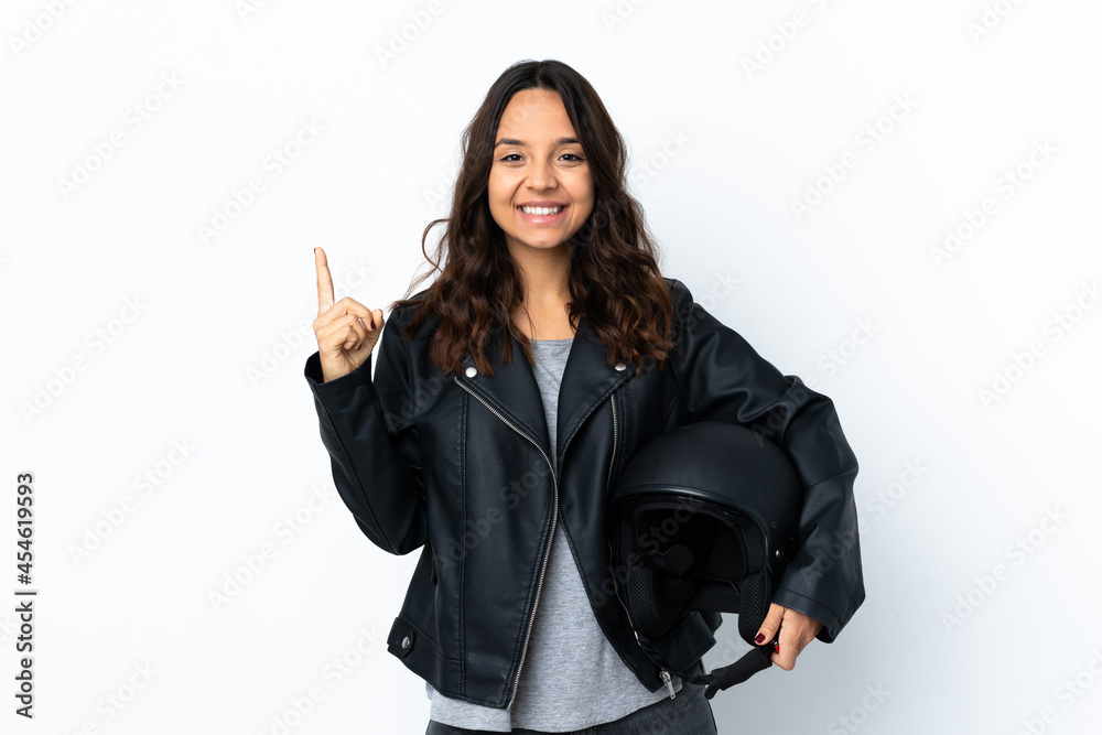 Young woman holding a motorcycle helmet over isolated white background pointing up a great idea Young woman holding a motorcycle helmet over isolated white background pointing up a great idea