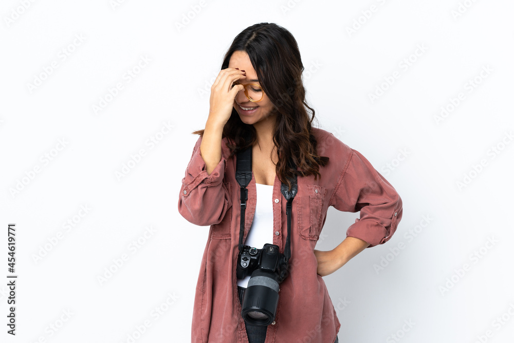 Young photographer woman over isolated white background laughing Young photographer woman over isolated white background laughing