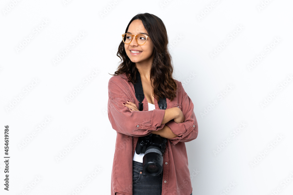 Young photographer woman over isolated white background looking to the side and smiling Young photographer woman over isolated white background looking to the side and smiling