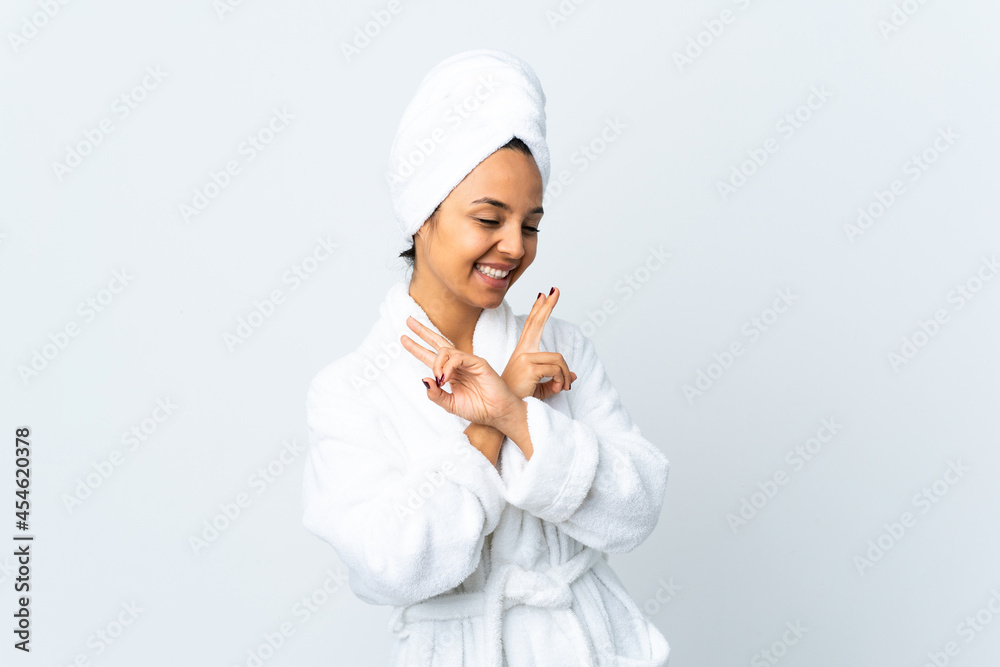 Young woman in bathrobe over isolated white background smiling and showing victory sign Young woman in bathrobe over isolated white background smiling and showing victory sign