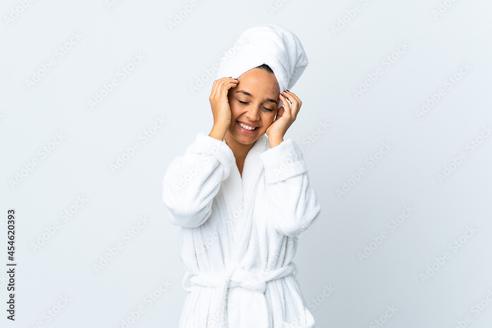 Young woman in bathrobe over isolated white background laughing Young woman in bathrobe over isolated white background laughing