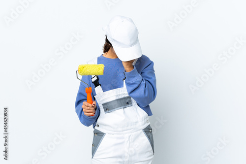 Painter woman over isolated white background with headache