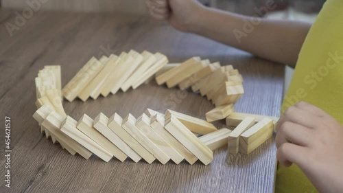 The child at the table starts a chain reaction as a domino effect