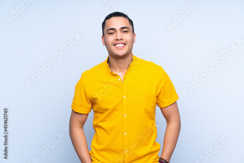 Asian handsome man over isolated background laughing