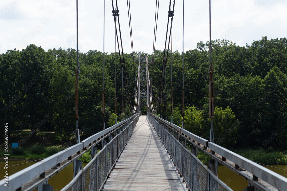 Obraz premium Pedestrian suspension bridge over river Neman