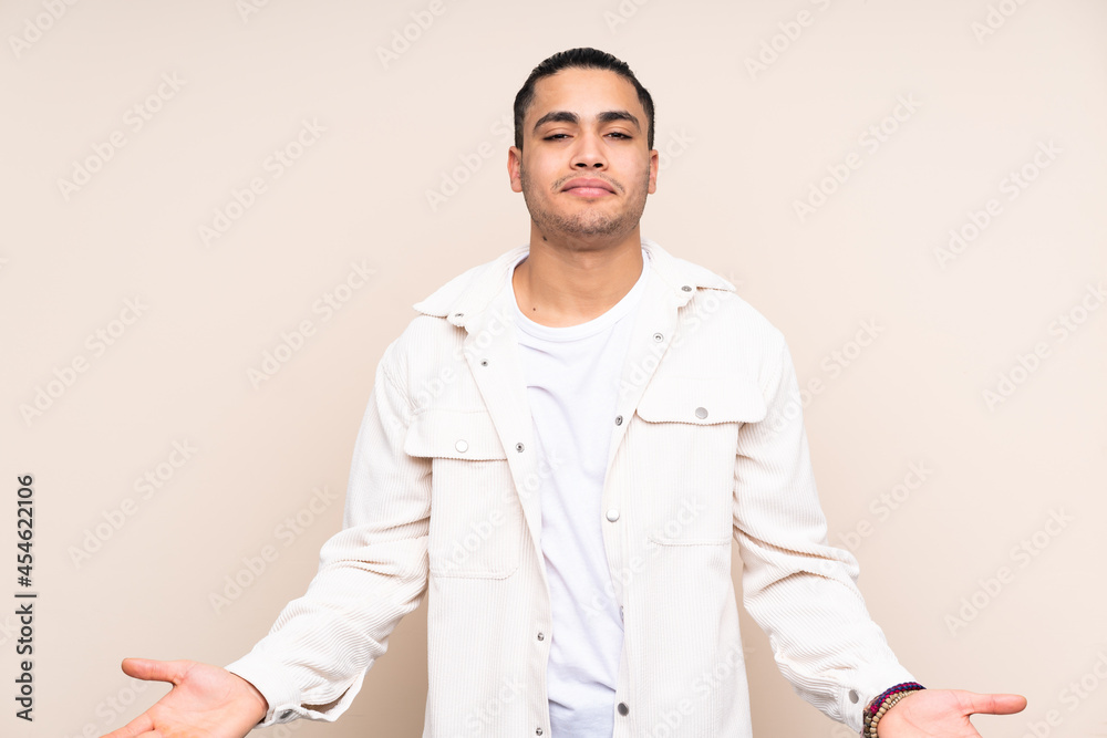 Asian handsome man over isolated background having doubts Asian handsome man over isolated background having doubts