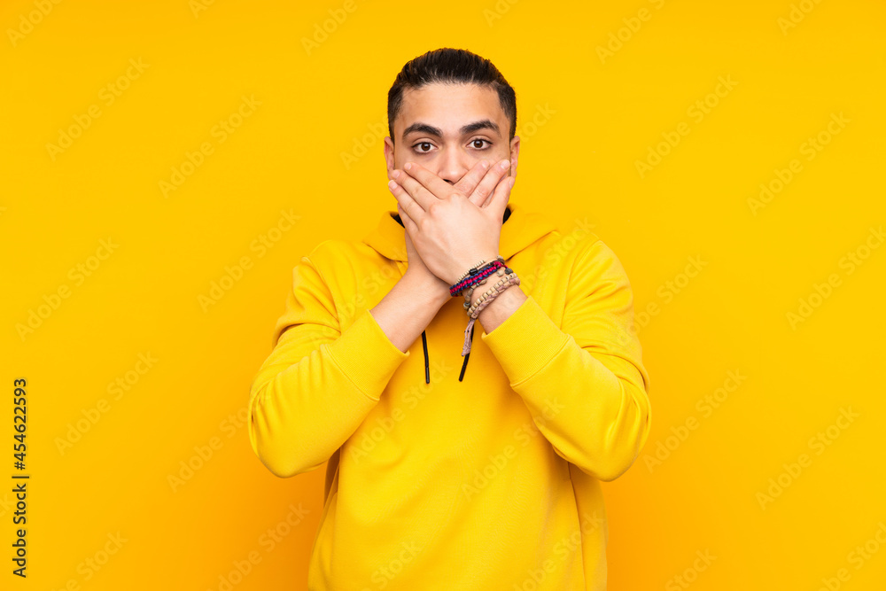 Asian handsome man isolated on yellow background in back position Asian handsome man isolated on yellow background in back position