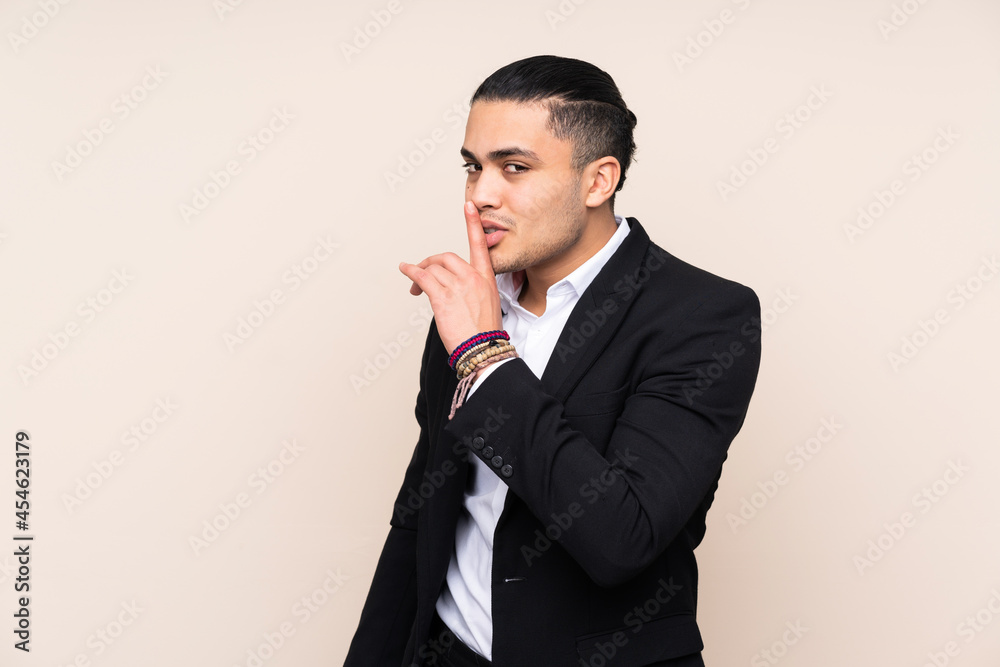 Asian business man isolated on beige background doing silence gesture Asian business man isolated on beige background doing silence gesture
