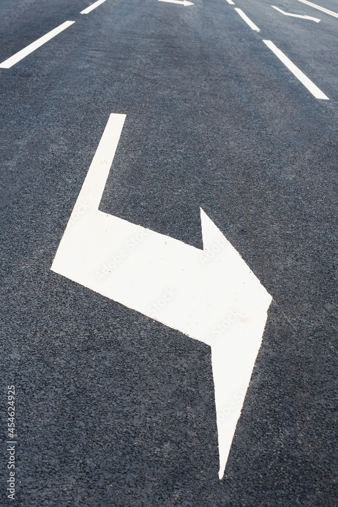 Arrow sign on the road. Road markings. Asphalt road. New road Arrow sign on the road. Road markings. Asphalt road. New road