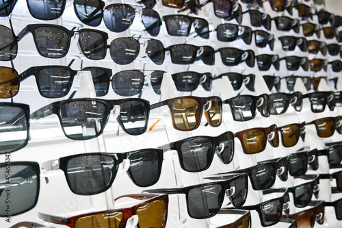 Lot of sunglasses on the counter of an optical store. Assortment of sunglasses. © Олег Арюткин