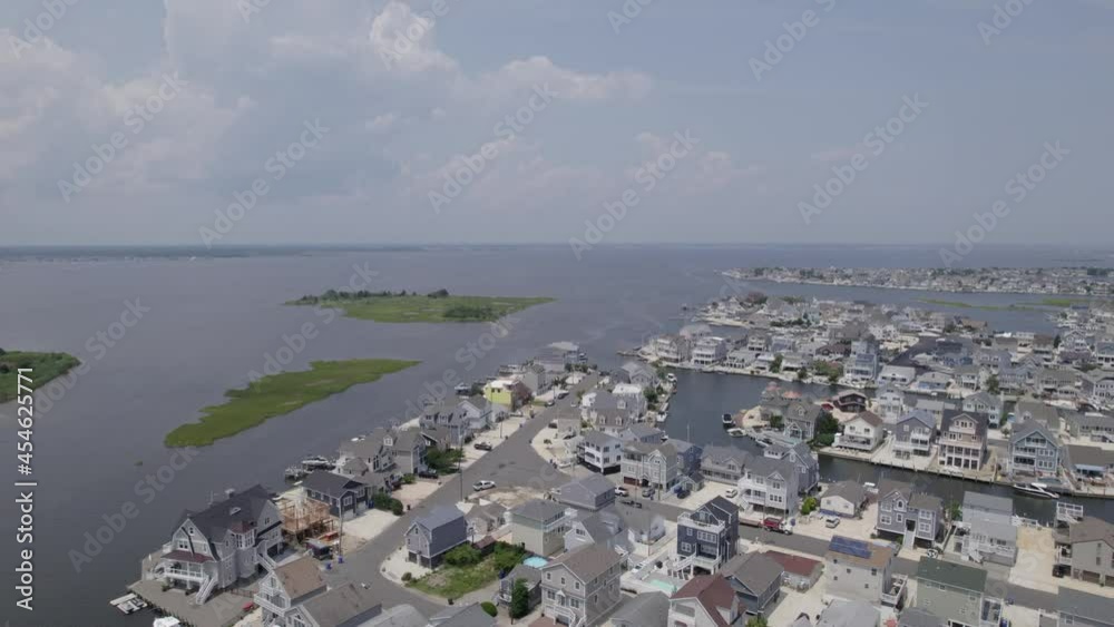 Drone flying over Jersey bay with island and housing