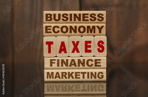 Wallpaper Mural Wooden blocks with the text - Business, Economy, Finance, Marketing and TAXES Torontodigital.ca