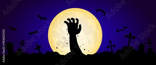 Zombie hand rising out of the grave in night with full moon. Halloween concert.