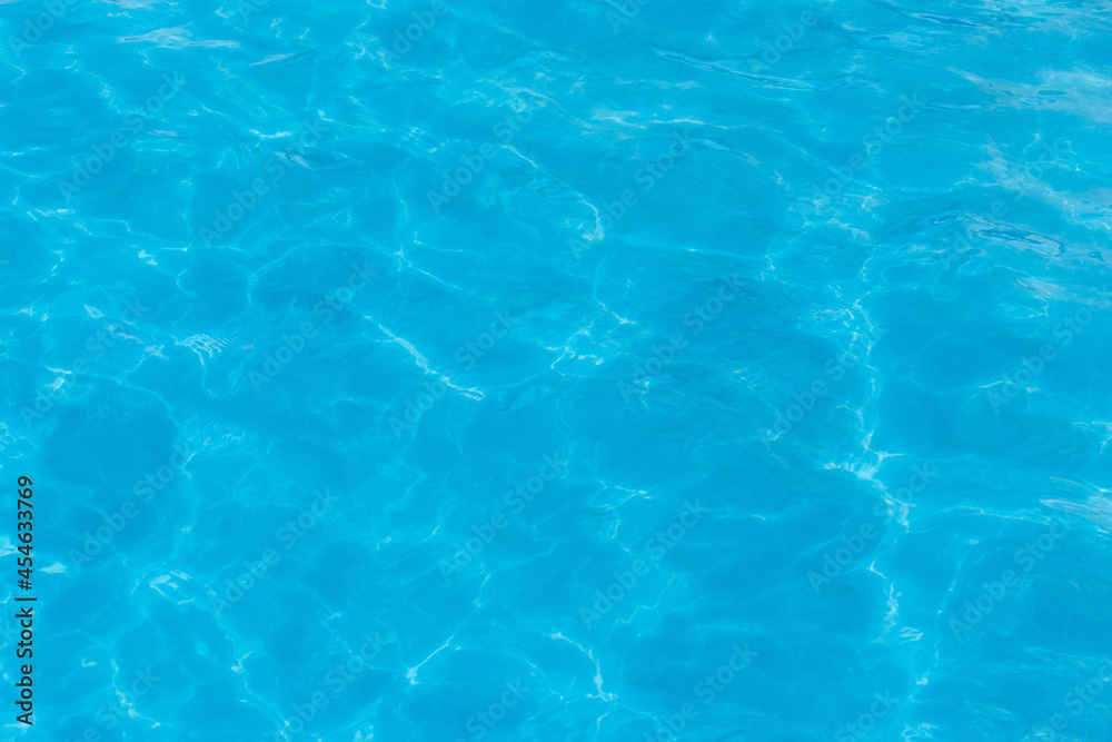 Blue clear pool water with abstract pattern of reflection and wave surface background