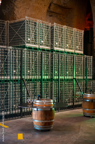 Visit of deep and long undergrounds caves for making champagne sparkling wine from chardonnay and pinor noir grapes in Reims, Champagne, France photo