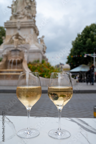 Drinking of brut champagne sparkling wine in street cafe in old central part of city Reims, Champagne, France
